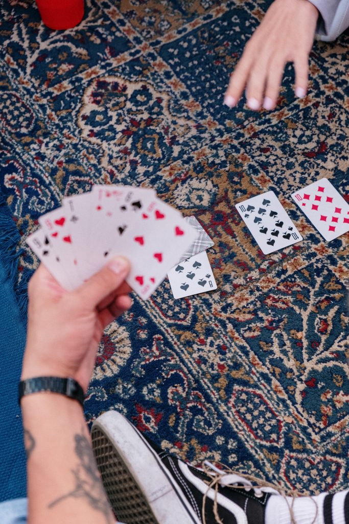 cards fanned out on a man's hand