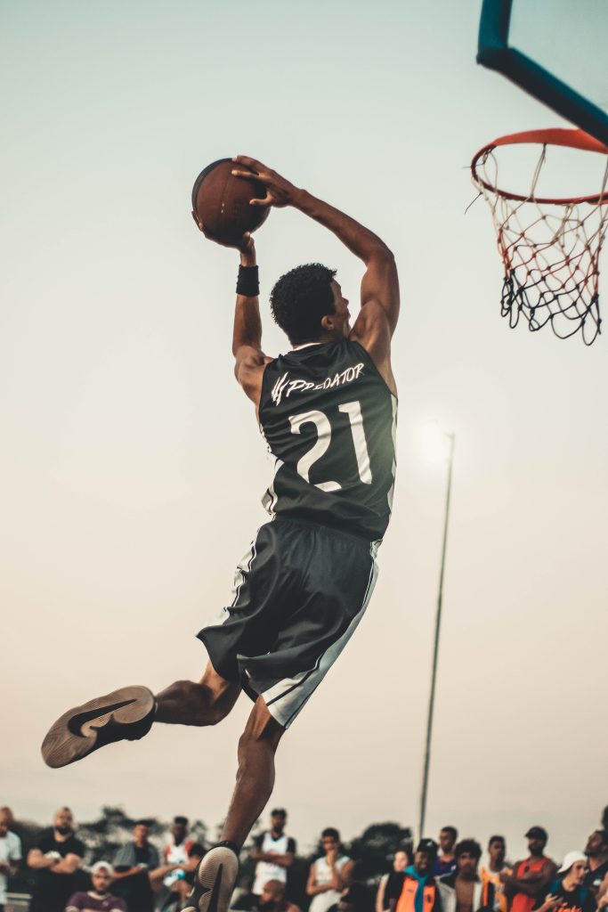 man in the process of doing a dunk