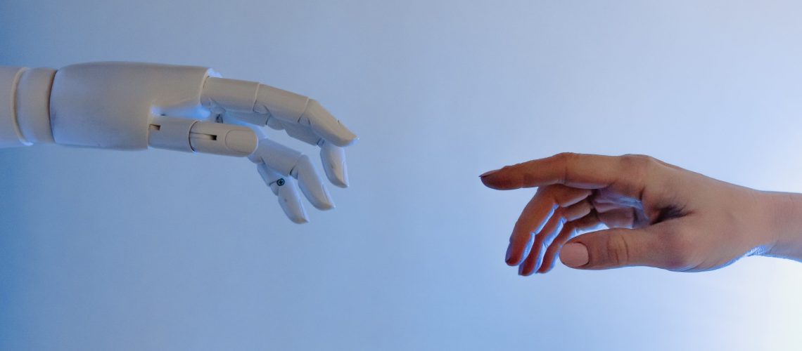 a human hand reaching out to touch a robot hand