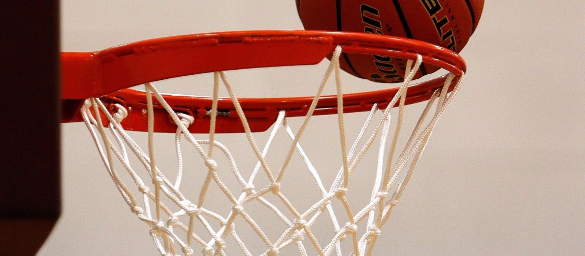 basketball on the rim of net