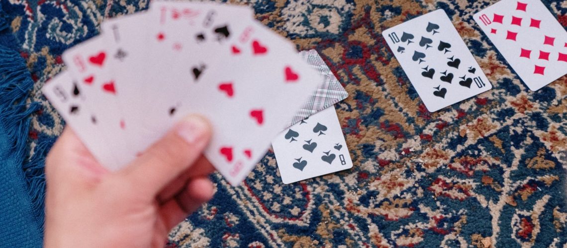 cards fanned out on a man's hand