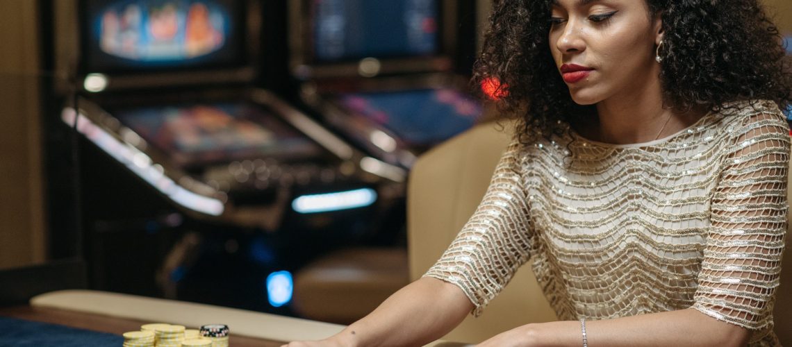 girl gambling, betting casino chips on the roulette table